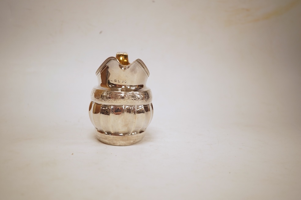 A George III engraved silver helmet shaped cream jug, with fluted body, Soloman Hougham?, London, 1800, height 97mm, 4.5oz (repair).